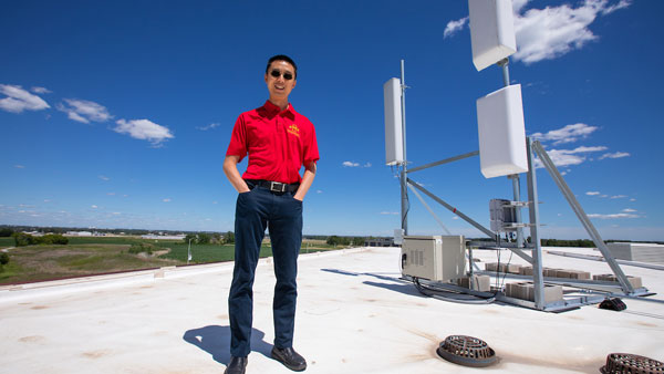 Hongwei on rooftop with equipment